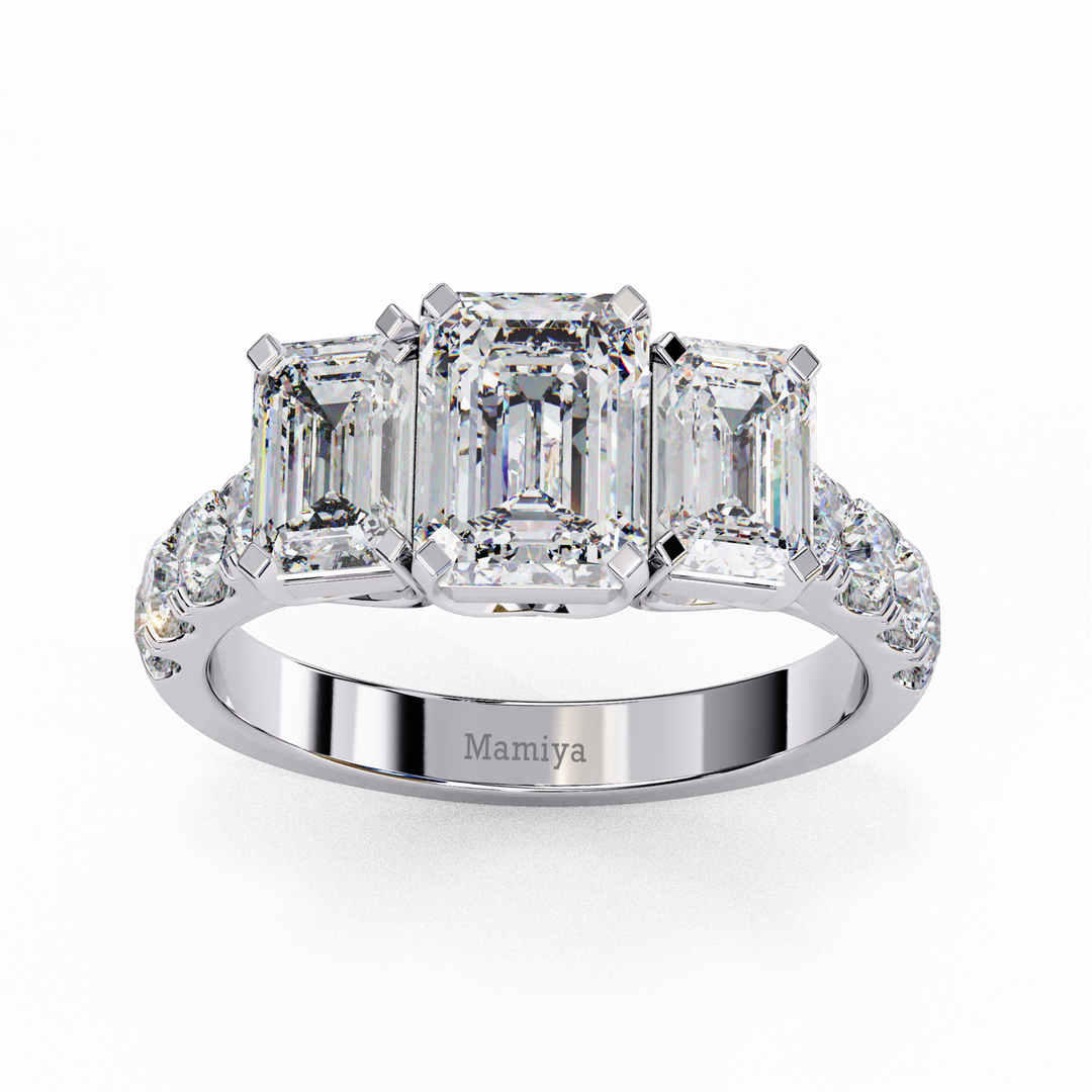 Three stone emerald cut engagement ring